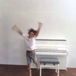 happy kid playing piano