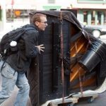 Colin Huggins rolling his baby grand piano
